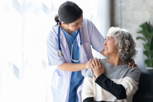 A caring nurse with a smiling senior woman at home in Northern Alabama